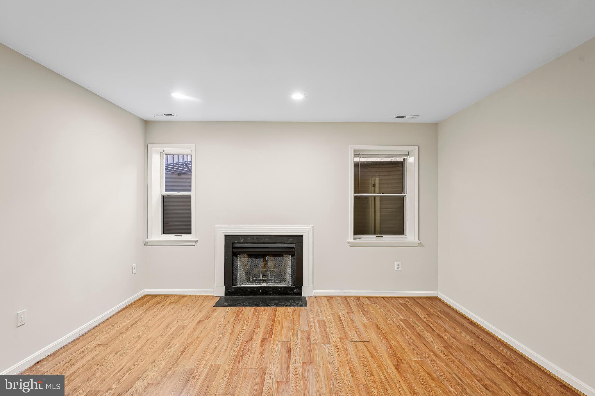 1469 Hampton Hill Circle McLean, VA 22101 - Photo 54 of 62 an empty room with wooden floor and a fireplace