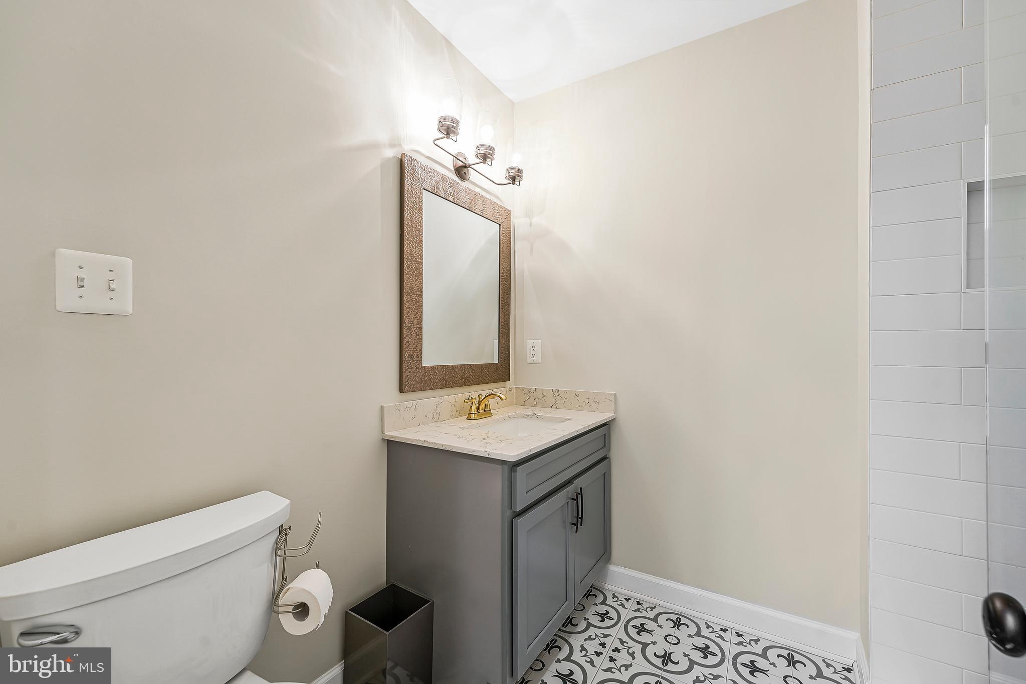 1469 Hampton Hill Circle McLean, VA 22101 - Photo 8 of 62 a bathroom with a toilet sink vanity and mirror