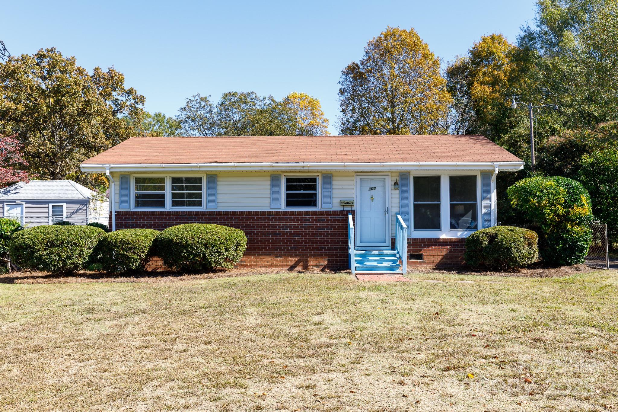 a view of a house with a yard and plants