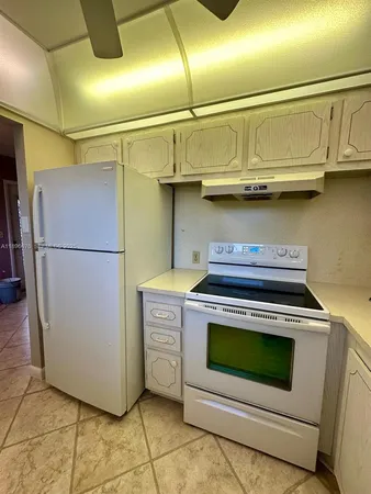 a kitchen with stainless steel appliances granite countertop a stove and a refrigerator