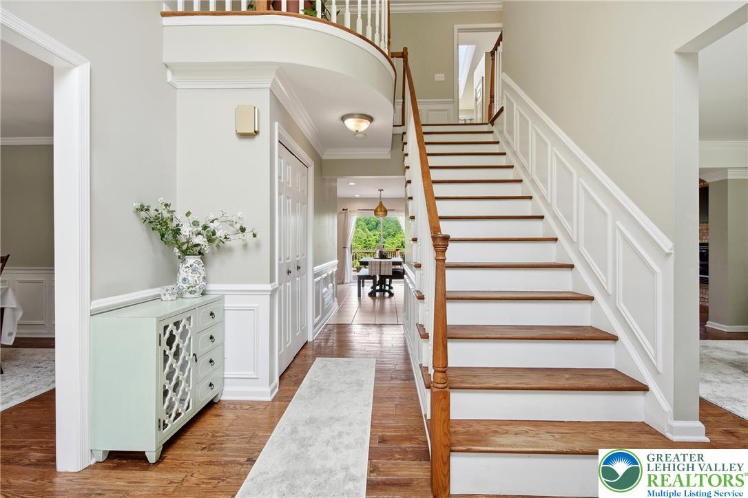 115 West Butternut Road Hellertown, PA 18055 - Photo 8 of 97 A grand entrance welcomes with a gracefully curved staircase and warm hardwood flooring.