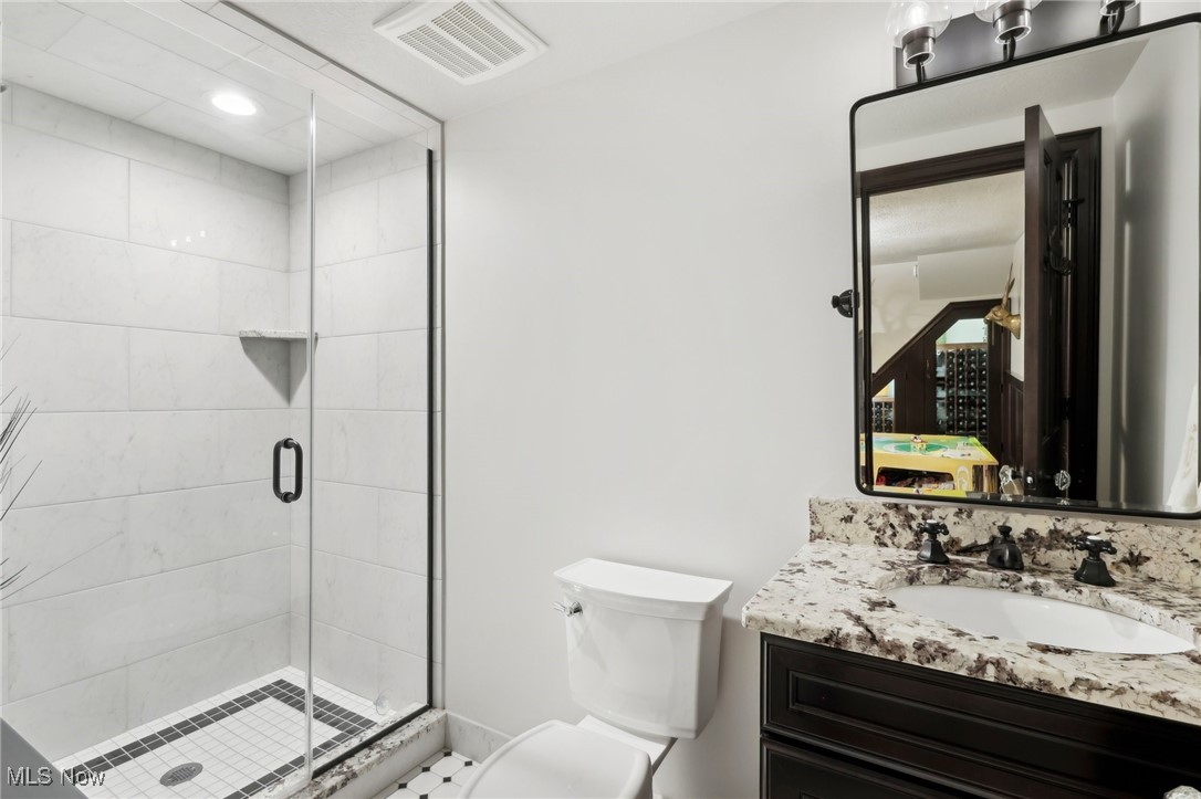 875 Mayfair Road Akron, OH 44303 - Photo 36 of 40 Bathroom featuring vanity, walk in shower, and toilet
