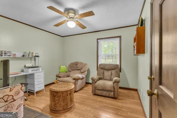 a bedroom with furniture and a flat screen tv