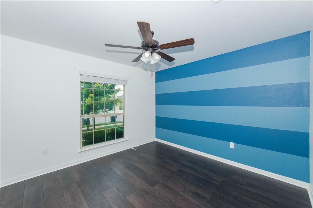 1007 Plateau Trail Georgetown, TX 78626 - Photo 23 of 32 a view of room with window and wooden floor