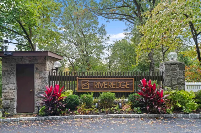 a sign that is sitting in front of flowers