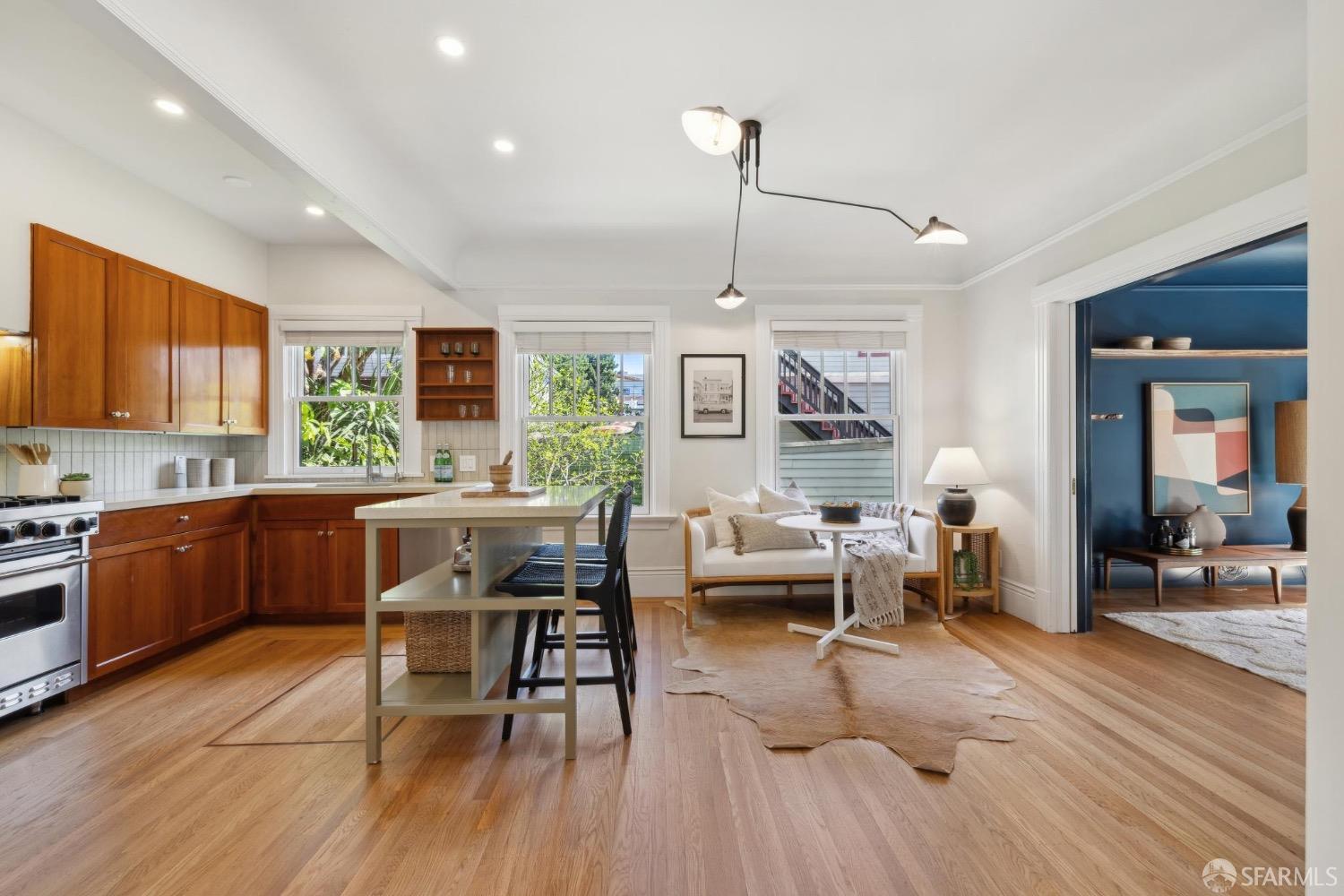 2341 Carleton Street Berkeley, CA 94704 - Photo 13 of 66 a living room with furniture a wooden floor and a window