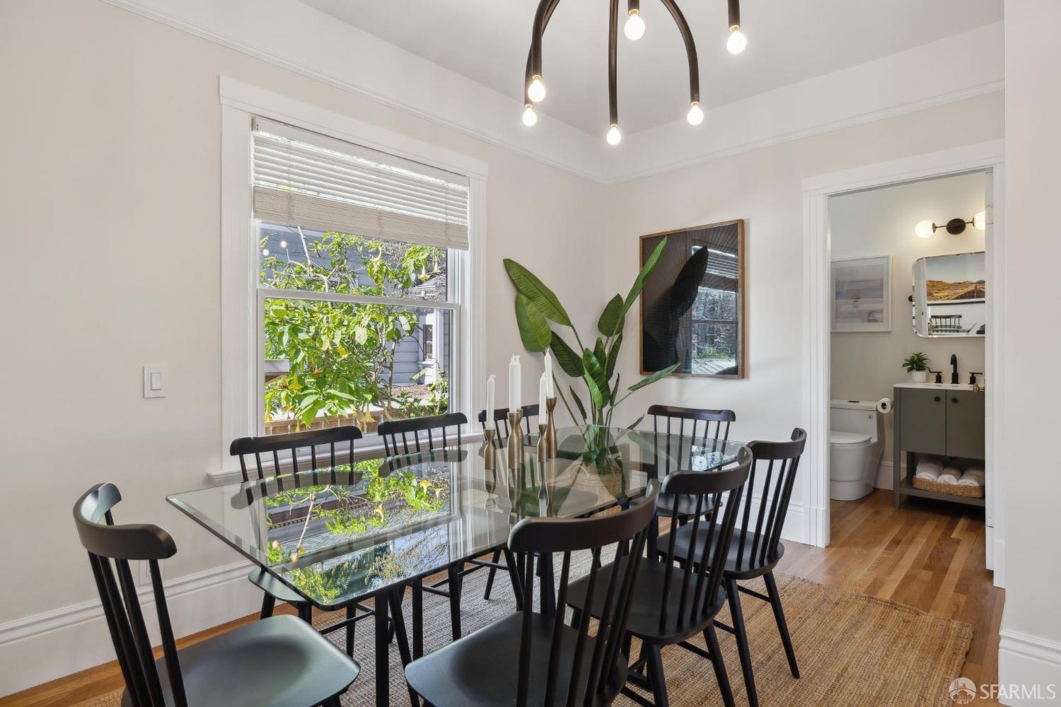 2341 Carleton Street Berkeley, CA 94704 - Photo 19 of 66 a view of a dining room with furniture window and wooden floor