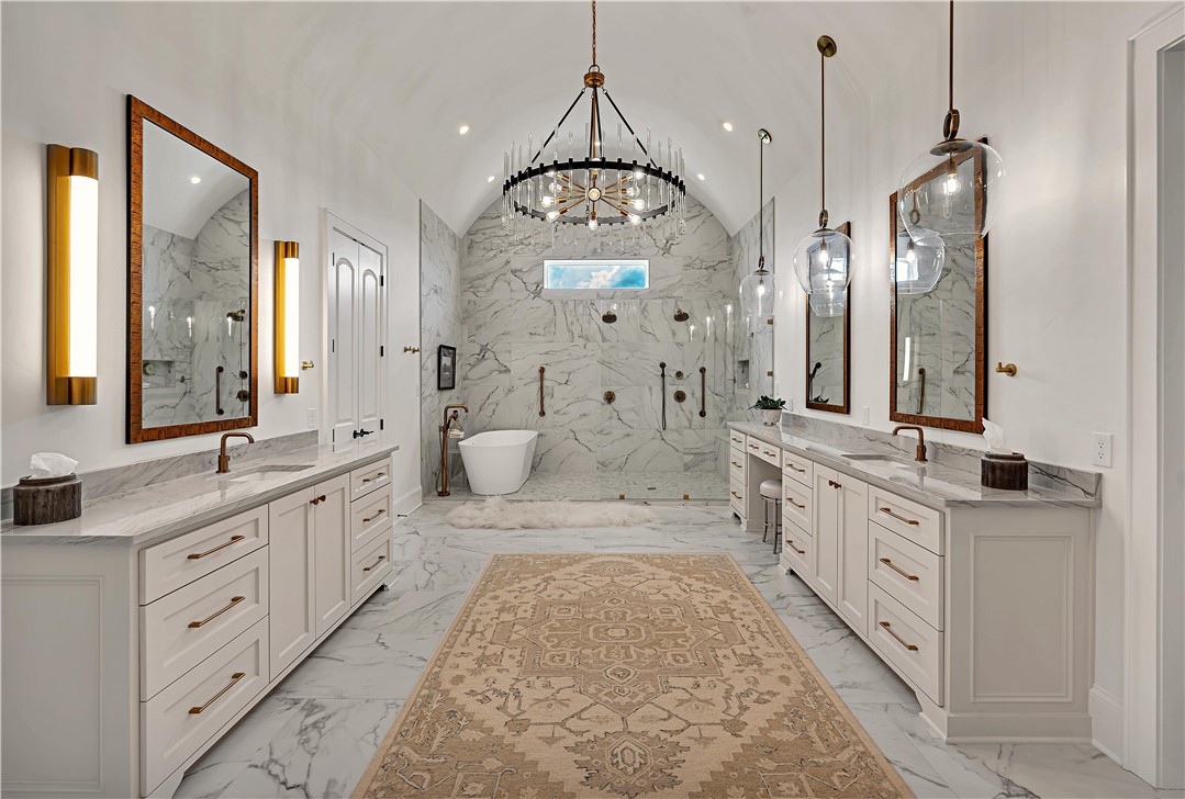 117 Iris Street Lorena, TX 76655 - Photo 17 of 82 a spacious bathroom with double vanity a double vanity sink a mirror a shower and a bathtub