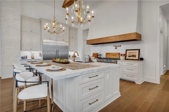 a kitchen with a stove and white cabinets