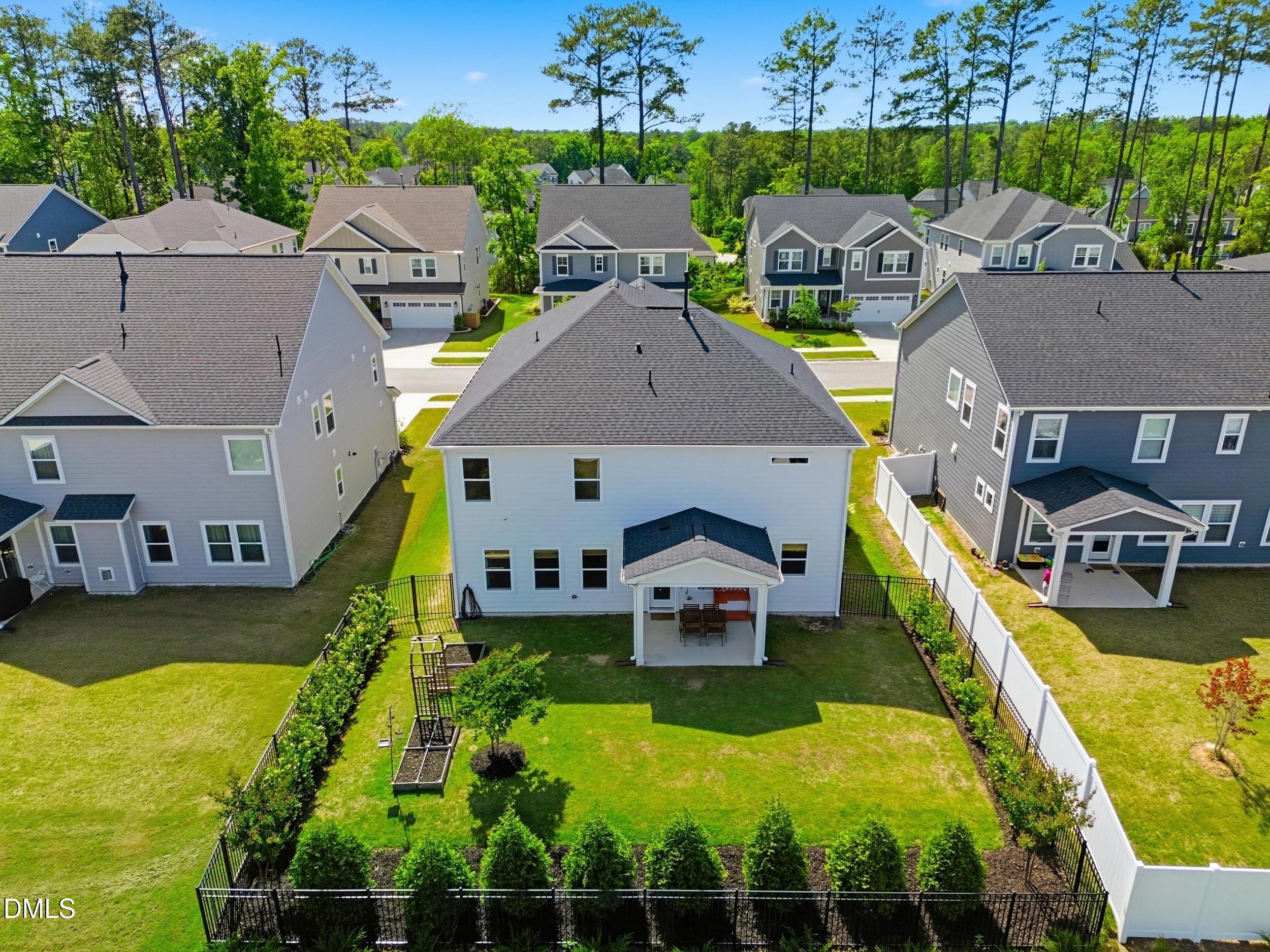 2709 Womble Ridge Drive New Hill, NC 27562 - Photo 7 of 60 an aerial view of a house with swimming pool and large trees
