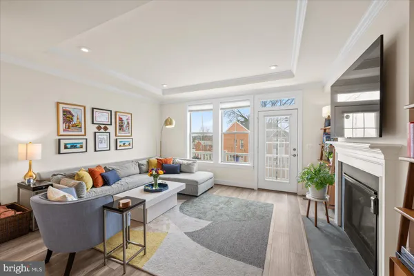 a living room with furniture fireplace and a large window