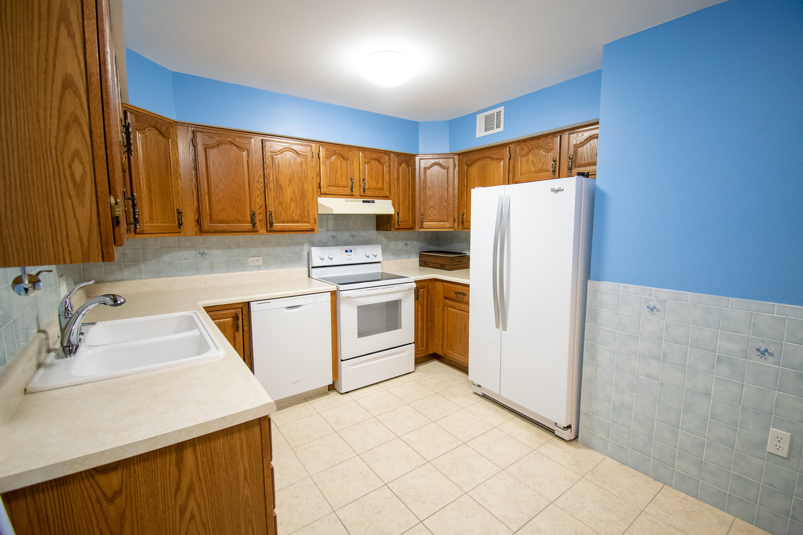 18300 Myrtle Court, Unit 3A Lansing, IL 60438 - Photo 11 of 20 a kitchen with a white cabinets sink and white stainless steel appliances