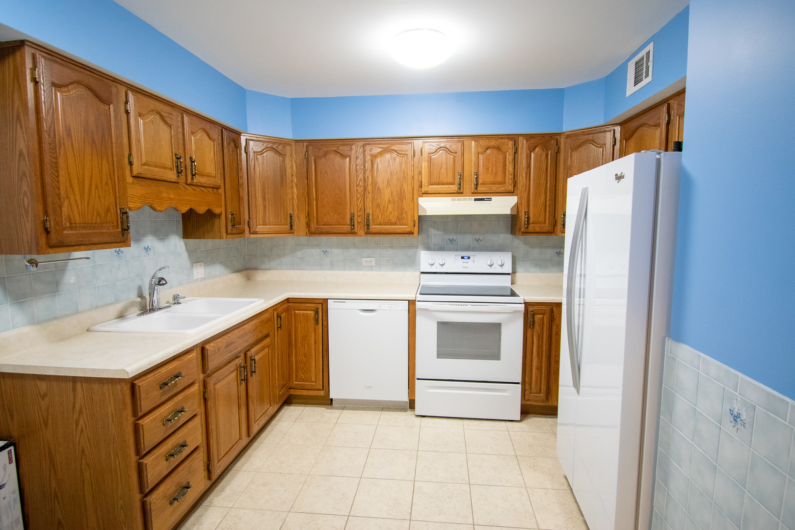 18300 Myrtle Court, Unit 3A Lansing, IL 60438 - Photo 13 of 20 a kitchen with white cabinets and white appliances