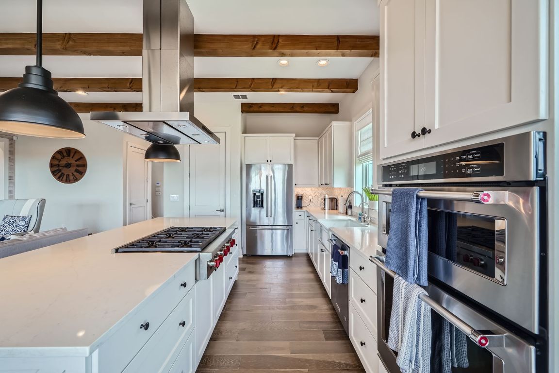 19517 Flying J Boulevard, Unit 8 Spicewood, TX 78669 - Photo 11 of 29 a kitchen with a stove and a refrigerator