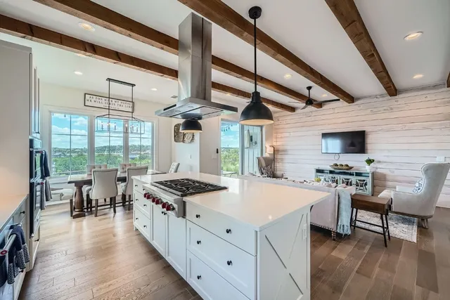 a kitchen with stainless steel appliances granite countertop a stove and a refrigerator