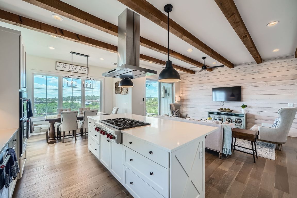 19517 Flying J Boulevard, Unit 8 Spicewood, TX 78669 - Photo 12 of 29 a kitchen with stainless steel appliances granite countertop a stove and a refrigerator