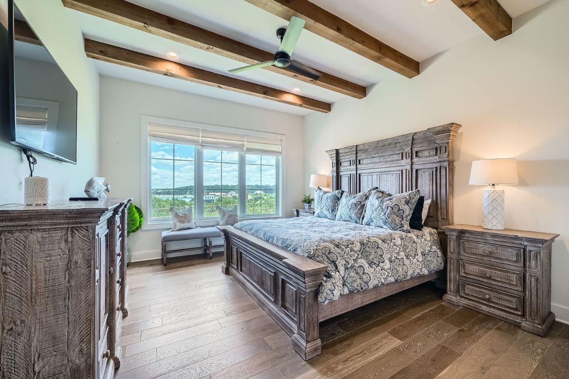 19517 Flying J Boulevard, Unit 8 Spicewood, TX 78669 - Photo 14 of 29 a bedroom with a bed and a flat screen tv