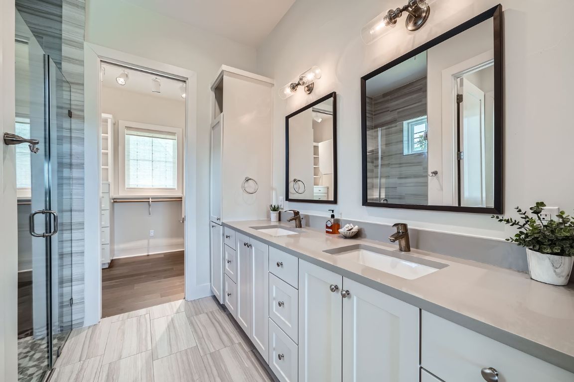 19517 Flying J Boulevard, Unit 8 Spicewood, TX 78669 - Photo 17 of 29 a bathroom with a double vanity sink and a mirror