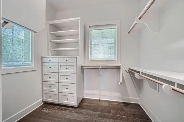 a view of walk in closet with empty racks