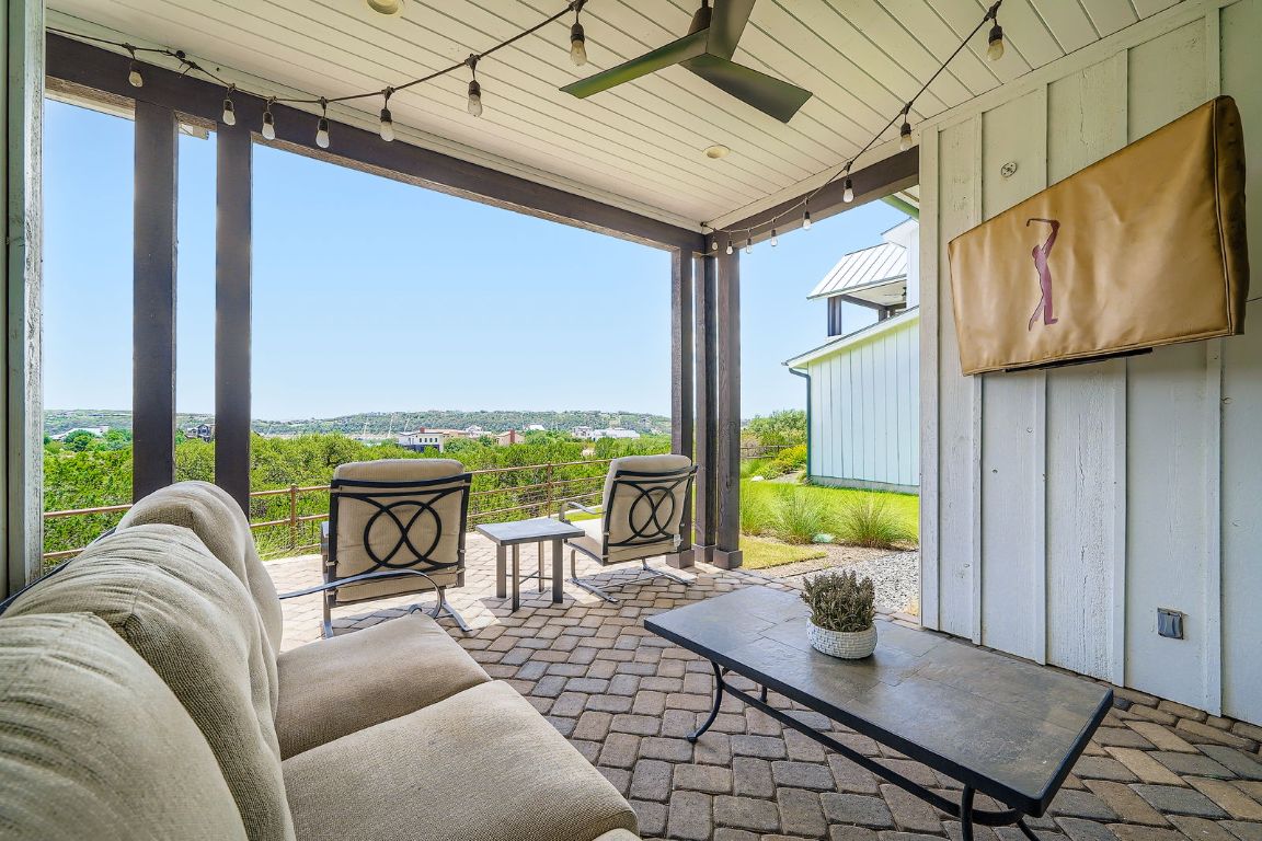19517 Flying J Boulevard, Unit 8 Spicewood, TX 78669 - Photo 28 of 29 a living room with furniture and a floor to ceiling window