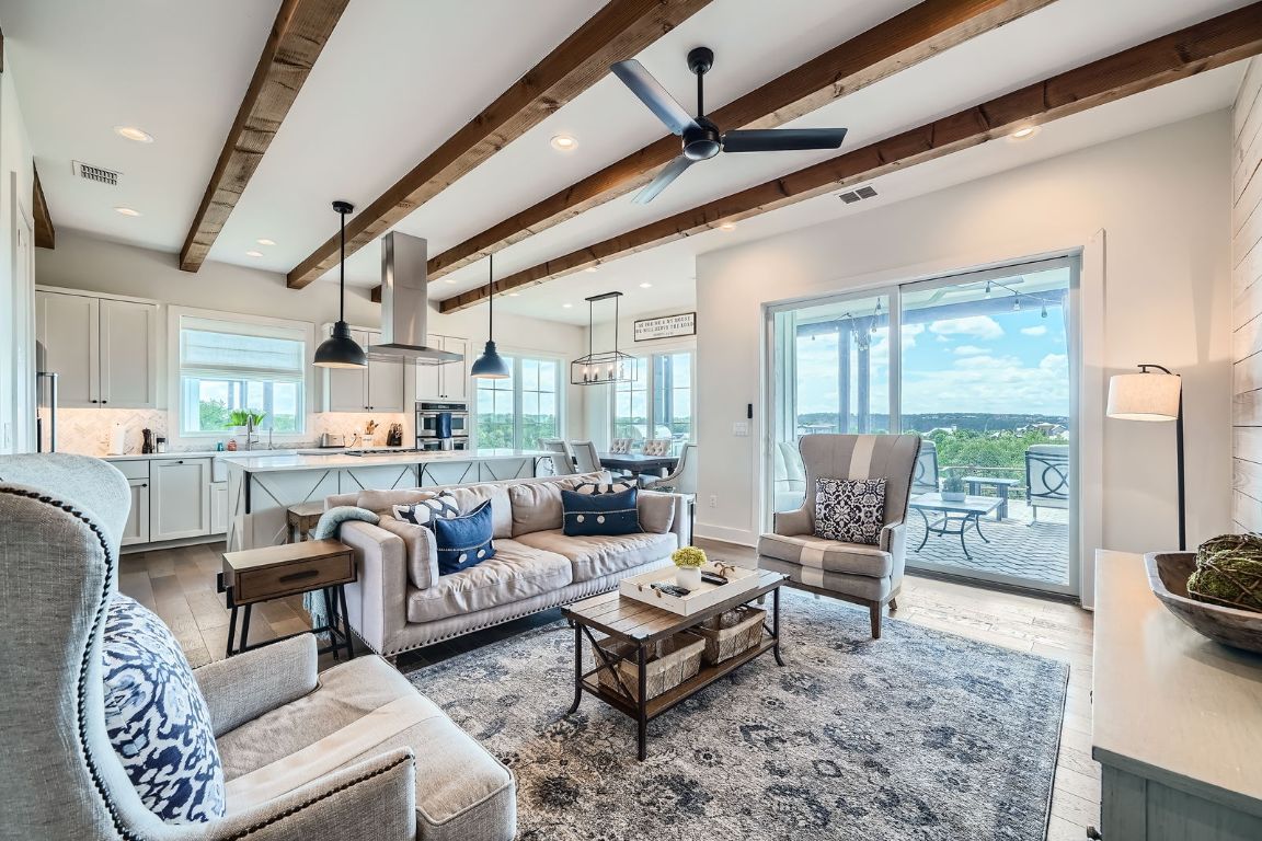19517 Flying J Boulevard, Unit 8 Spicewood, TX 78669 - Photo 6 of 29 a living room with furniture and a large window