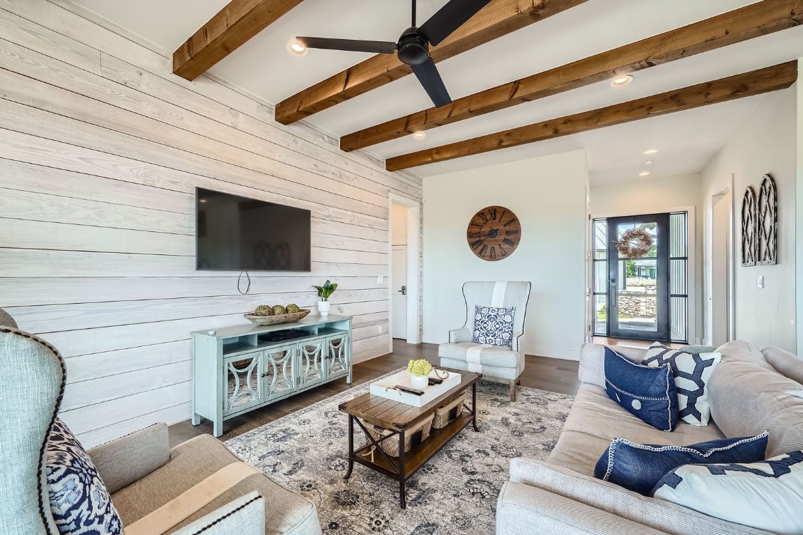 19517 Flying J Boulevard, Unit 8 Spicewood, TX 78669 - Photo 7 of 29 a living room with furniture a rug and a flat screen tv