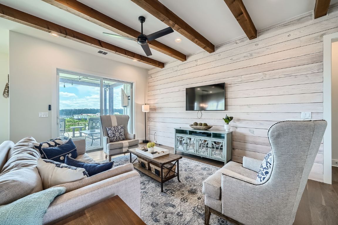19517 Flying J Boulevard, Unit 8 Spicewood, TX 78669 - Photo 8 of 29 a living room with furniture and a flat screen tv