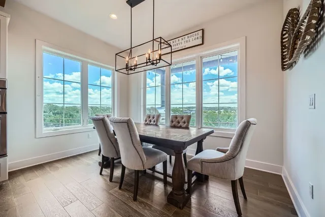 a view of a dining room with furniture window and wooden floor