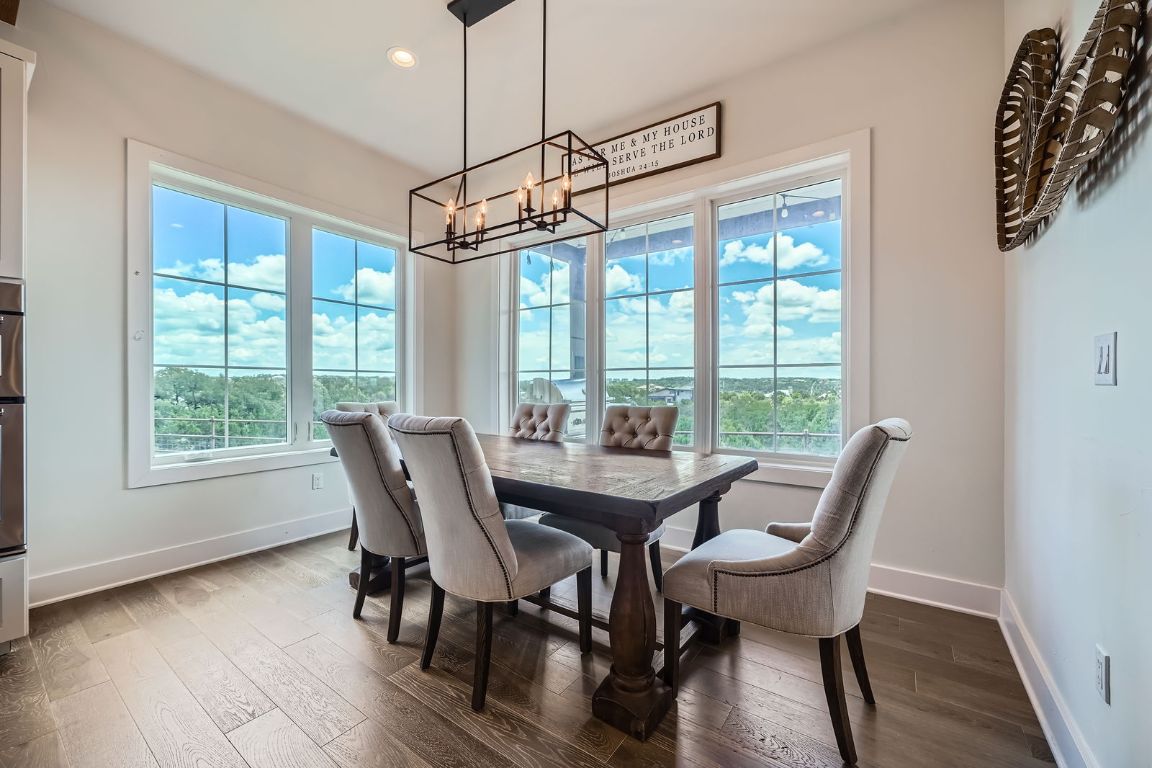 19517 Flying J Boulevard, Unit 8 Spicewood, TX 78669 - Photo 10 of 29 a view of a dining room with furniture window and wooden floor
