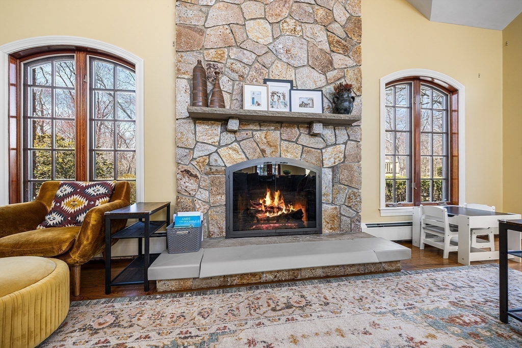 a living room with furniture a rug a fireplace and a table