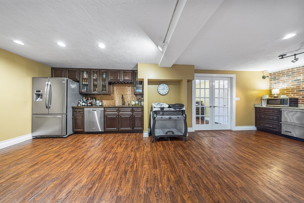 23 Landers Road Stoneham, MA 02180 - Photo 15 of 42 a kitchen with sink a refrigerator and wooden floor
