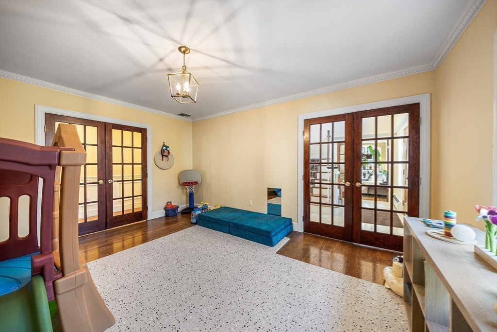 23 Landers Road Stoneham, MA 02180 - Photo 16 of 42 a bedroom with a large bed and a chandelier