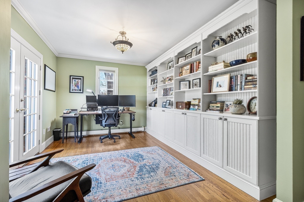 23 Landers Road Stoneham, MA 02180 - Photo 17 of 42 a living room with furniture and a book shelf