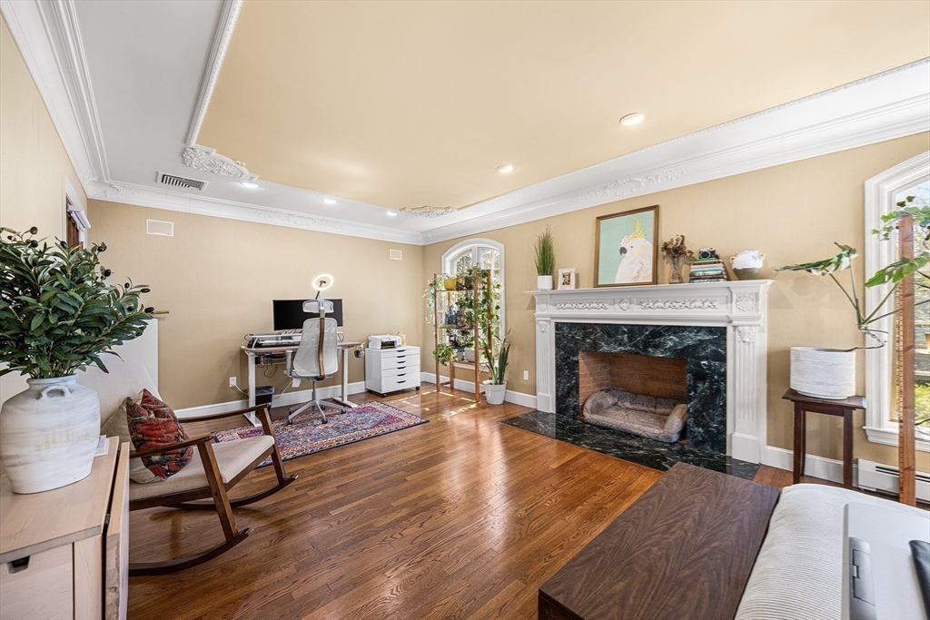 23 Landers Road Stoneham, MA 02180 - Photo 21 of 42 a living room with furniture and a fireplace