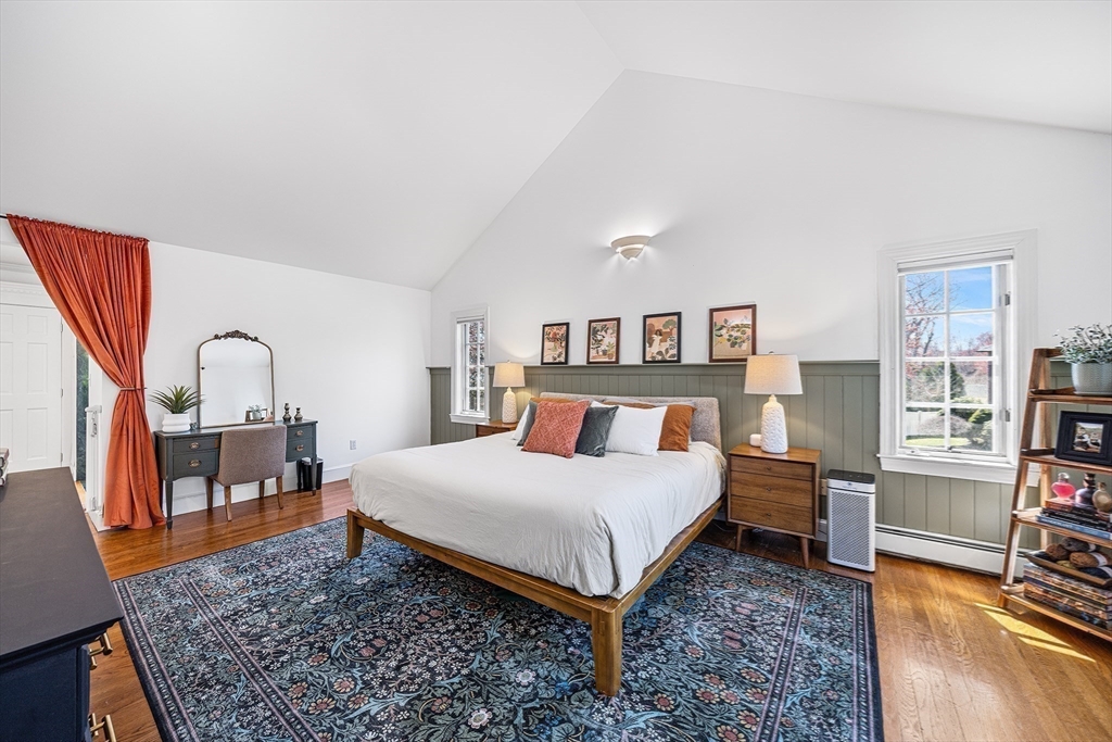 23 Landers Road Stoneham, MA 02180 - Photo 24 of 42 a bedroom with a bed a table and dresser