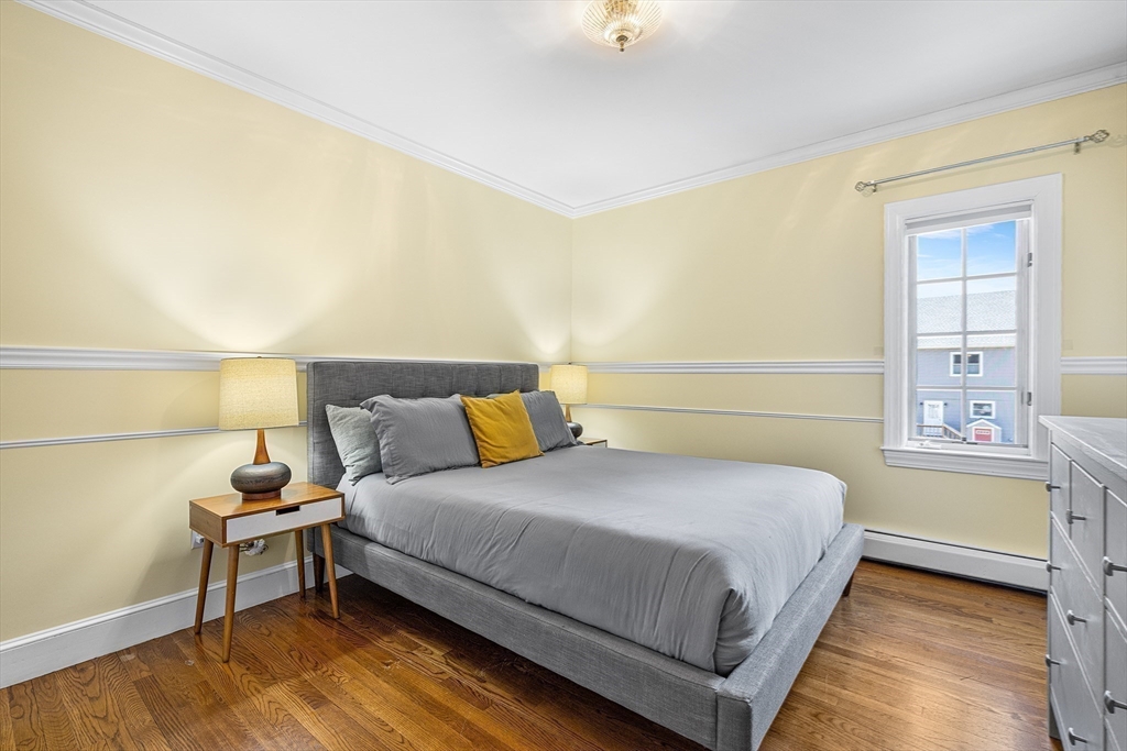 23 Landers Road Stoneham, MA 02180 - Photo 25 of 42 a bedroom with a bed and a night stand