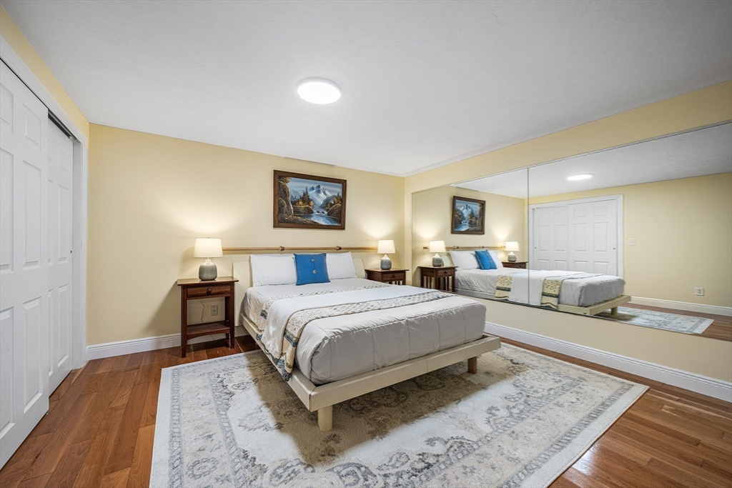 23 Landers Road Stoneham, MA 02180 - Photo 27 of 42 a spacious bedroom with a bed and a couch