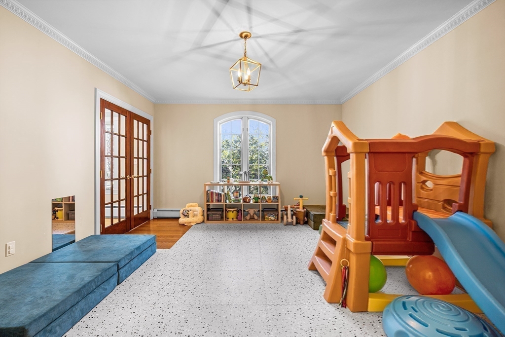 23 Landers Road Stoneham, MA 02180 - Photo 29 of 42 a bedroom with furniture and a chandelier