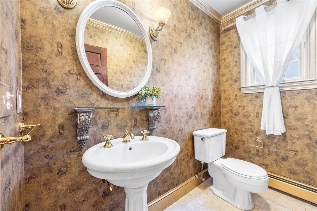 23 Landers Road Stoneham, MA 02180 - Photo 30 of 42 a bathroom with a sink a toilet and a mirror