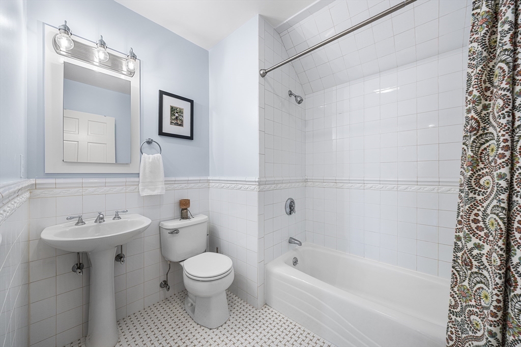 23 Landers Road Stoneham, MA 02180 - Photo 31 of 42 a bathroom with a sink toilet and shower