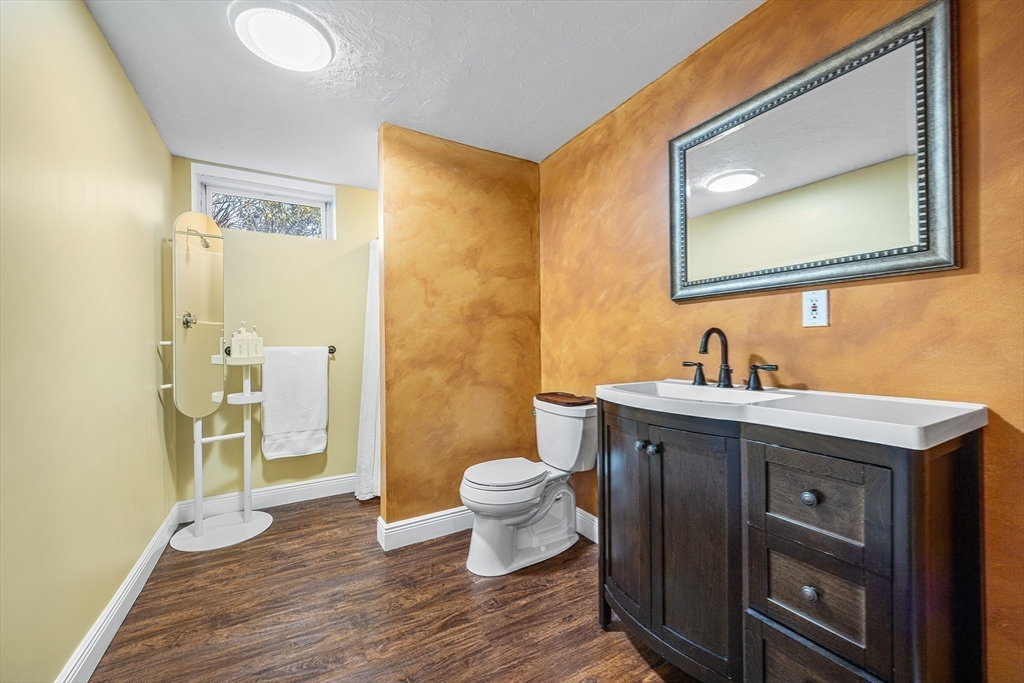 23 Landers Road Stoneham, MA 02180 - Photo 32 of 42 a bathroom with a toilet sink and mirror