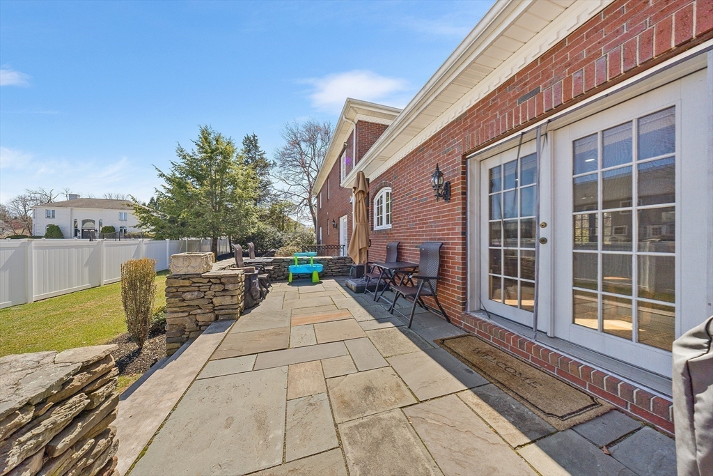 23 Landers Road Stoneham, MA 02180 - Photo 38 of 42 a view of a patio with table and chairs with wooden floor and fence