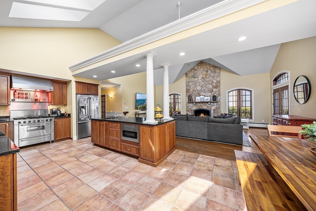 23 Landers Road Stoneham, MA 02180 - Photo 7 of 42 a large kitchen with stainless steel appliances microwave and stove
