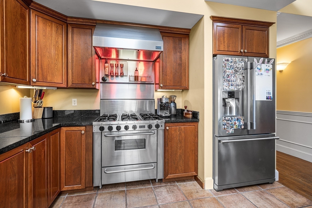 23 Landers Road Stoneham, MA 02180 - Photo 8 of 42 a kitchen with stainless steel appliances granite countertop a refrigerator and a stove