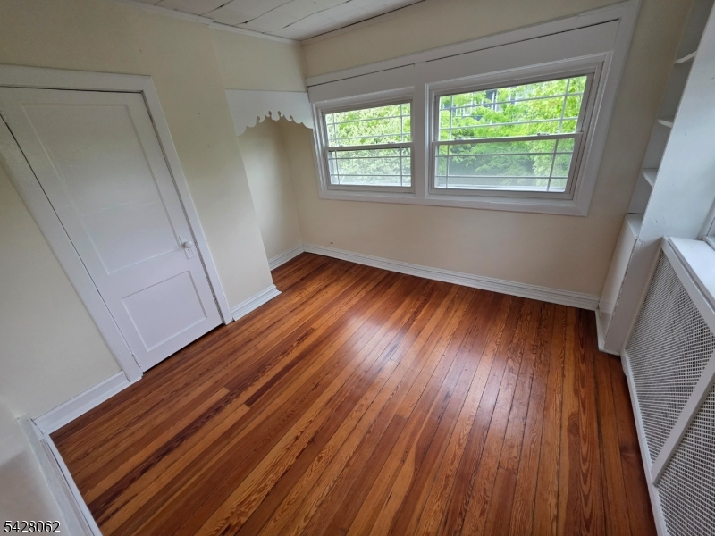 71 Montclair Avenue Montclair, NJ 07042 - Photo 13 of 25 a view of an empty room with wooden floor and a window