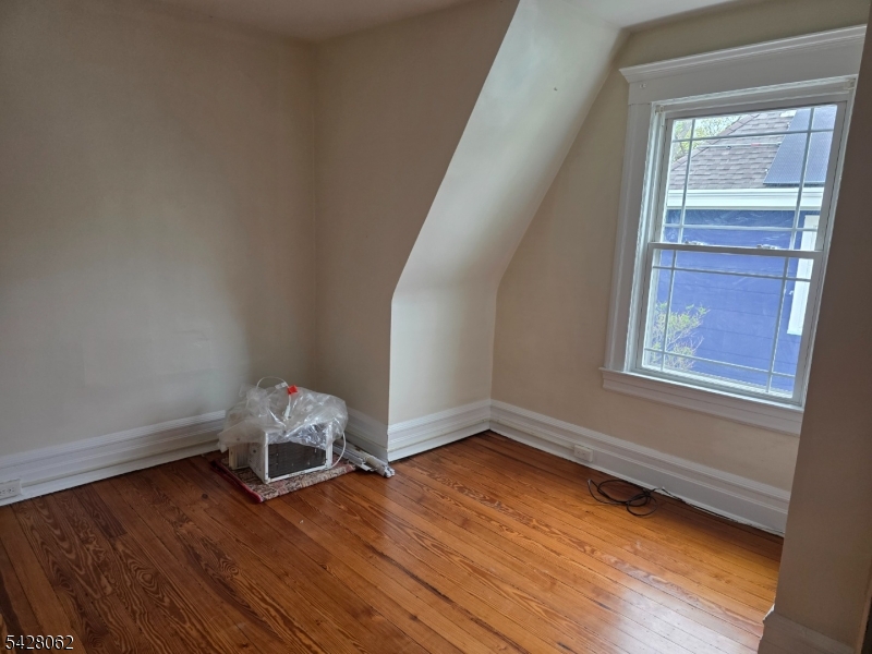 71 Montclair Avenue Montclair, NJ 07042 - Photo 20 of 25 an empty room with wooden floor and windows