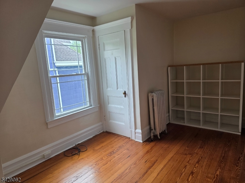 71 Montclair Avenue Montclair, NJ 07042 - Photo 22 of 25 an empty room with wooden floor and windows