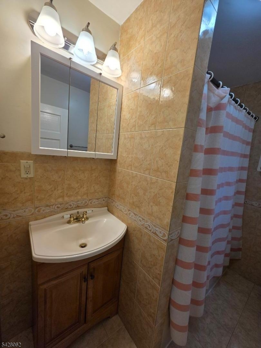71 Montclair Avenue Montclair, NJ 07042 - Photo 25 of 25 a bathroom with a sink and a mirror