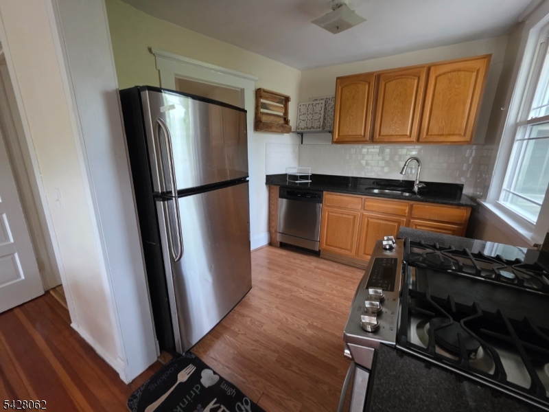 71 Montclair Avenue Montclair, NJ 07042 - Photo 4 of 25 a kitchen with wooden cabinets and a stainless steel appliances