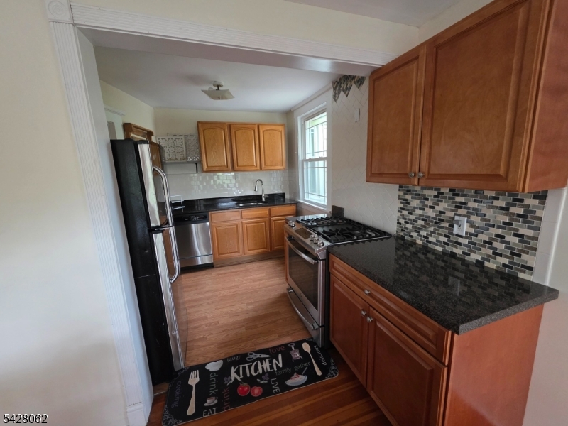 71 Montclair Avenue Montclair, NJ 07042 - Photo 5 of 25 a kitchen with wooden cabinets and a stove top oven